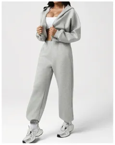Grey zip hoodie and sweatpants detail showing soft fleece texture and relaxed fit style.
