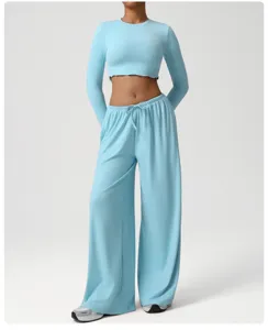 Close-up detail of light blue crop top and loose yoga pants set, soft breathable fabric.