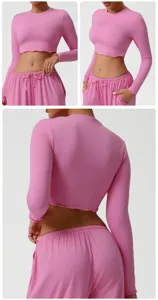 Pink activewear set featuring long sleeve crop top and drawstring sweatpants for workout.