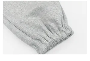 Close-up detail of gray casual sweatpants elastic cuff showing soft textured fabric texture.