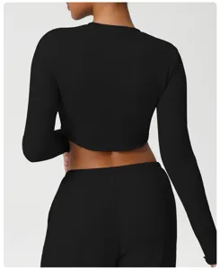 Back view detail of slim-fit black long sleeve yoga top, breathable and comfortable fabric.