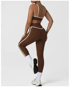 High-waist athletic leggings and sports bra set in brown with white contrast piping details.