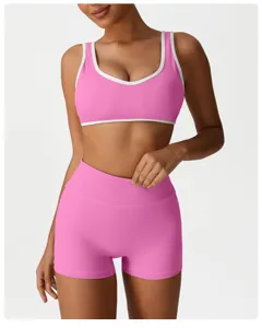 Pink sports yoga set with contrast trim bra and high waist shorts for workout activewear.