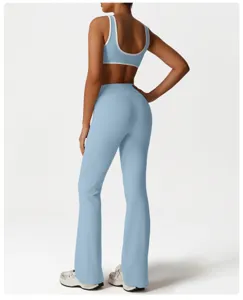 Back view of light blue women activewear set with contrast trim sports bra and flared yoga pants