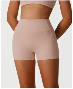High-waisted women's fitness sports shorts, nude pink yoga activewear for running and gym.
