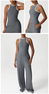 Grey athletic tank top and loose trousers detail shot, showing contrast trim and pockets.