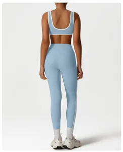 Back view of light blue sports bra and high waist yoga leggings set with white trim details.