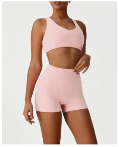 Pink athletic set featuring a cropped sports bra and high-waisted shorts for women fitness.
