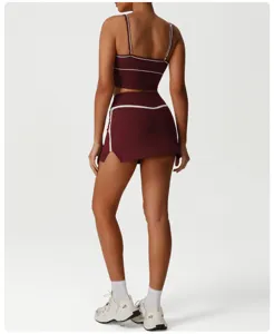 Detailed back view of the maroon athletic crop top and sports skirt set with white piping trim.
