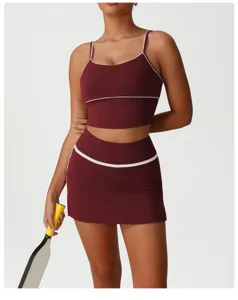 Detailed view of maroon athletic crop top and skirt set with elegant white piping trim