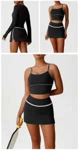 Black athletic two-piece set detail view, featuring white piping and tight-fitting design.