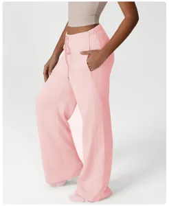 Close-up detail of casual wide-leg sweatpants in light pink with high waist and side pockets.