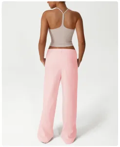Conjunto deportivo casual de mujer con top corto halter y pantalón rosa holgado.