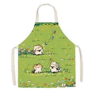 Cute cartoon cat apron detail shot, fabric kitchen cooking bib with sweet floral meadow design.