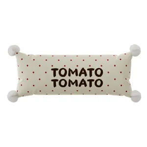 Cute decorative bolster pillow with red polka dots and corner pom-poms for cozy living room sofa.