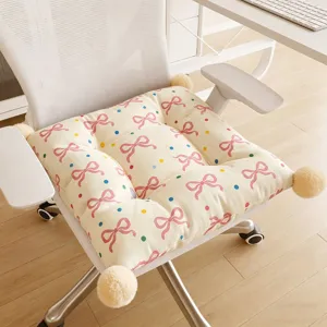 Detail view of a Korean style bow cushion with pom-poms, thick and soft for chair.