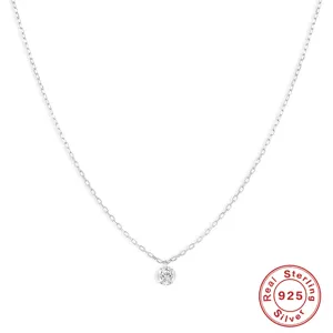 Macro view of minimalist 925 sterling silver necklace with sparkling round diamond pendant