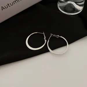 Minimalist silver hoop earrings, large geometric statement earrings for women, stylish fashion jewelry.