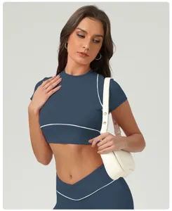 Dettaglio in primo piano dell'elegante top corto con profili a contrasto e leggings sportivi.