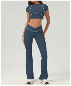 Dettaglio ravvicinato del top sportivo blu scuro e dei pantaloni da yoga a zampa incrociata.