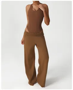 Detailed shot of the brown ribbed bodysuit and loose casual wide-leg sweatpants worn by model.