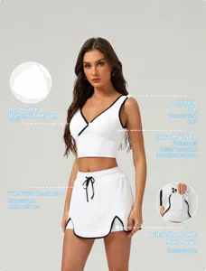 Detailed view of women athletic crop top and skirt set with contrast trim and built-in shorts.