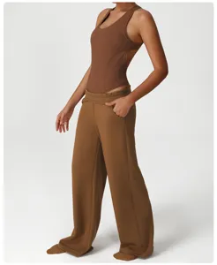 Detail shot of brown ribbed bodysuit paired with loose wide-leg sweatpants featuring pockets.