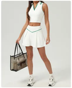 Details of the white sporty polo crop top and pleated tennis skirt with green trim.