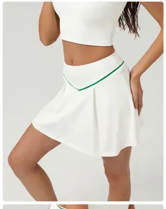 White pleated tennis skirt with green trim high waist activewear athletic short skirt detail