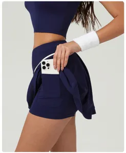 Detail close-up of women high waist athletic tennis skort showing convenient side phone pocket.
