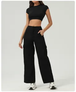 Detail shot of black crop top and cargo pants set, slim fit style, premium fabric.