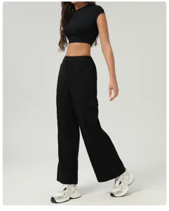 Detail shot of the women casual black cargo pants and slim crop top outfit, stylish streetwear.