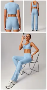 Light blue seamless yoga workout set detail, featuring high waist leggings, shorts and bra.