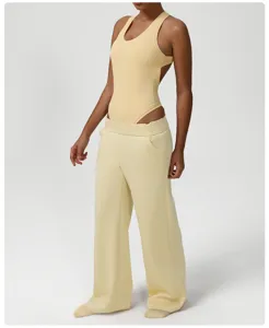 Stylish yellow ribbed bodysuit paired with wide-leg sweatpants for comfortable casual wear.