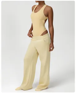 Stylish yellow sleeveless bodysuit with matching loose wide-leg sweatpants set for women.