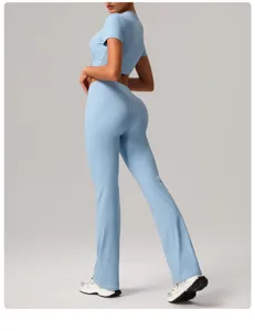 Detail shot of light blue high-waisted flared yoga pants and crop top set, premium stretch fabric.
