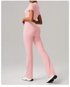 Pink yoga set featuring a short sleeve crop top and high waist flare pants for fitness.