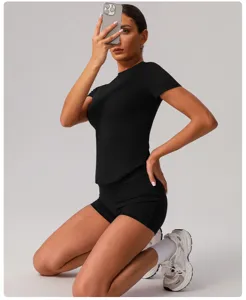 Detail view of black seamless yoga set, short sleeve top and tight shorts for women fitness.