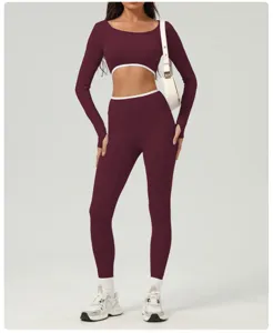 Detail view of burgundy long sleeve crop top and high waist yoga pants athletic set.
