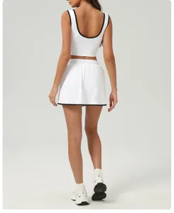 Ensemble haut de sport et jupe blanc avec bordure noire. Tenue respirante pour le yoga et le fitness.