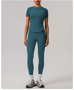 Detailed view of teal solid yoga set, stretchy breathable activewear top and leggings.