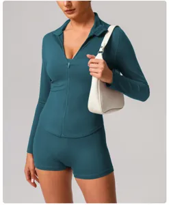 Close-up detail view of the teal long sleeve activewear zip top and matching athletic shorts set.