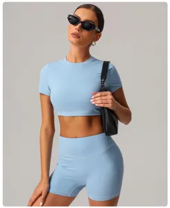 Women solid light blue short sleeve crop top and yoga shorts set for sporty fitness wear.