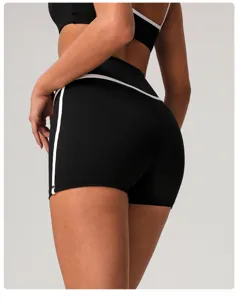 Detail view of black high waist yoga shorts with white trim and butt lifting design.