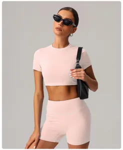 Women pink crop top and shorts athletic yoga set detail view for fitness and casual wear.