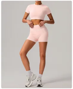 Close-up details of the pink short sleeve crop top and yoga shorts set showing the nice fit.