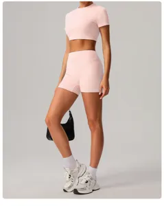 Detail view of pink activewear set, crop top and high waist shorts for fitness yoga.