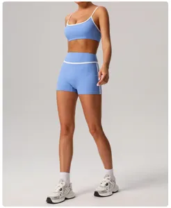 Close-up detail of women's light blue athletic shorts and sports bra set with white contrast trim.