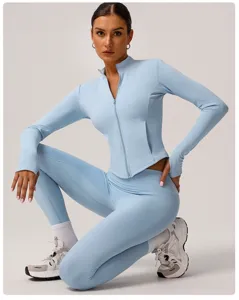 Close-up detail of the light blue athletic zip-up top and high-waist fitness leggings.