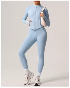 Detail view of women activewear yoga set featuring long sleeve zip jacket and high waist pants.